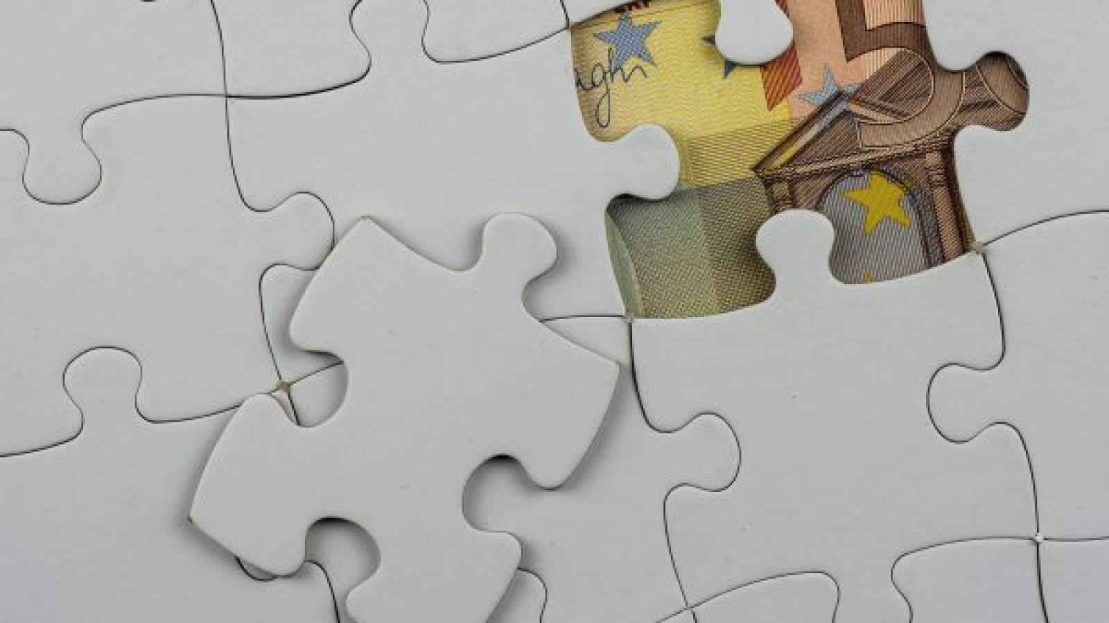 top-view-puzzle-pieces-with-money-it-concept-business compressed